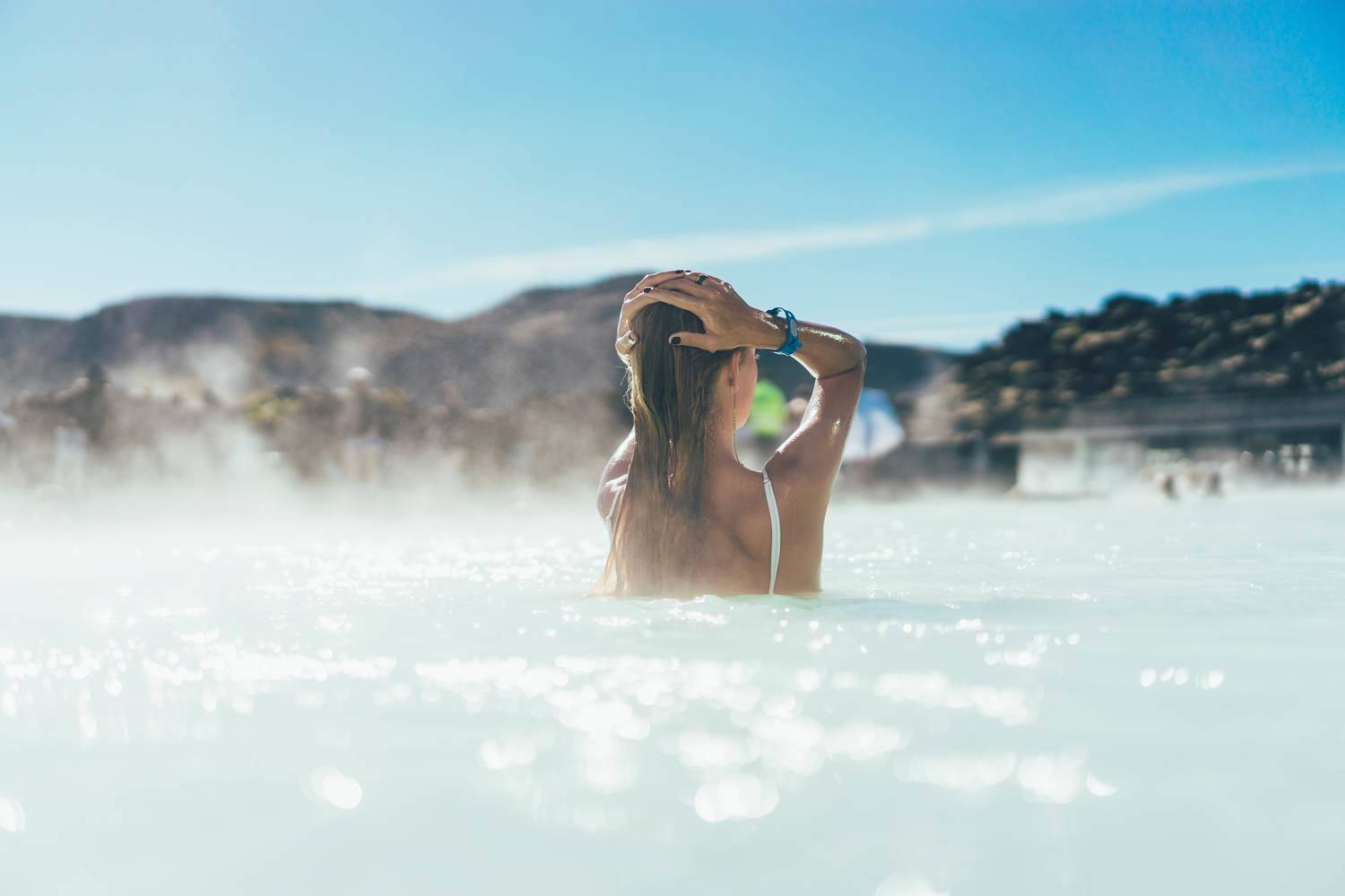 back-view-of-young-woman-relaxing-in-hot-pool-in-i-2022-02-01-22-39-57-utc